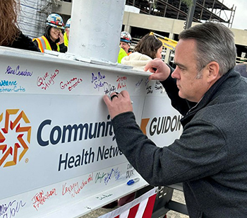 Dr. Patrick McGill signing beam