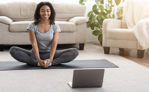 Woman doing virtual yoga at home