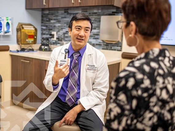 Dr. Wei consulting with an oncology patient