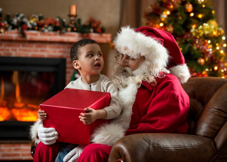 Child sitting with Santa Claus