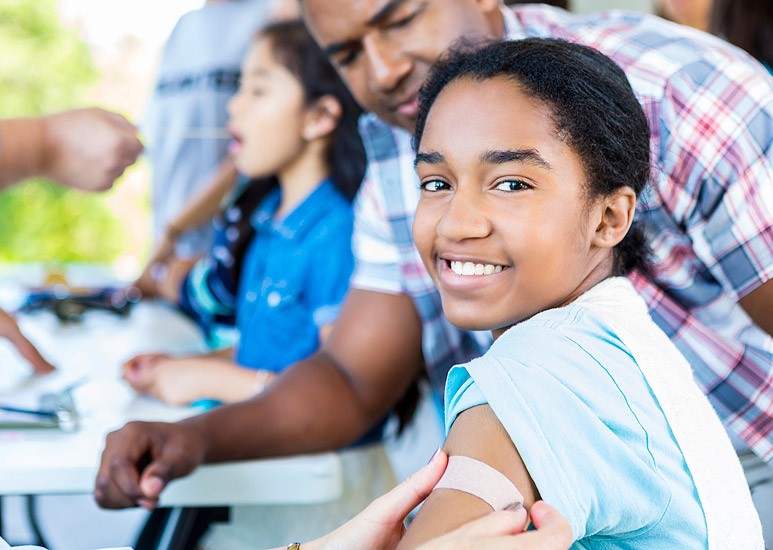 Girl smiling after flu shot