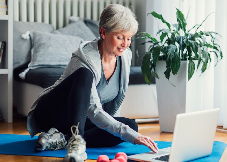Senior woman exercising at home
