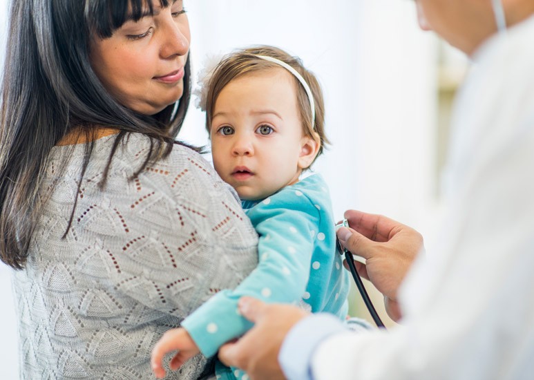 Mom holding ill baby