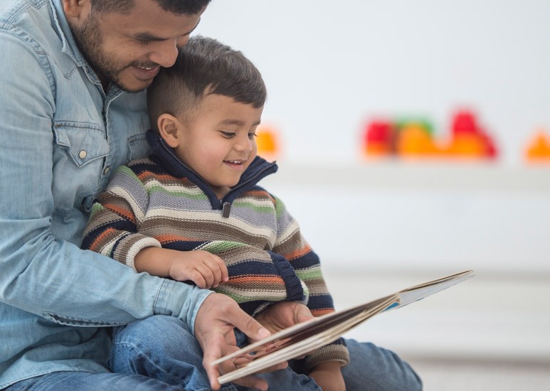 Father reading aloud to son
