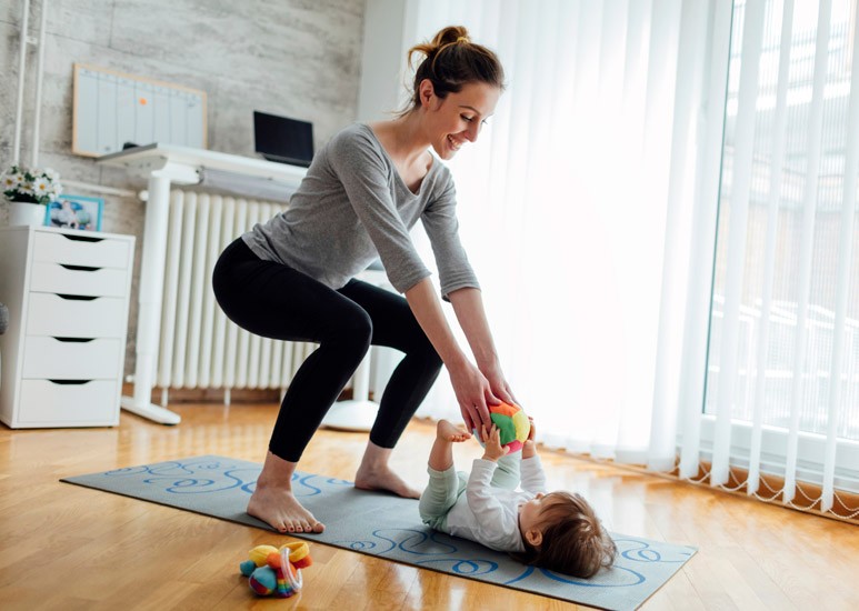 Mom exercising at home with baby