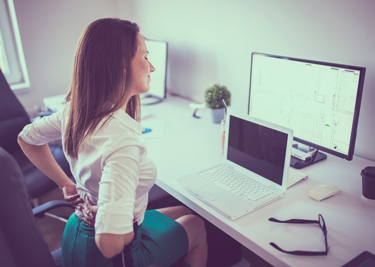 Woman with back pain at the office