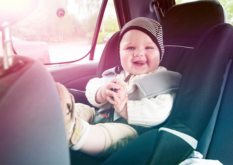 Infant in car seat in back seat of car