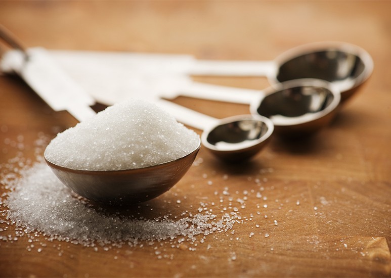 measuring spoon full of sugar