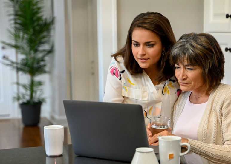 Mom and adult daughter using a laptop