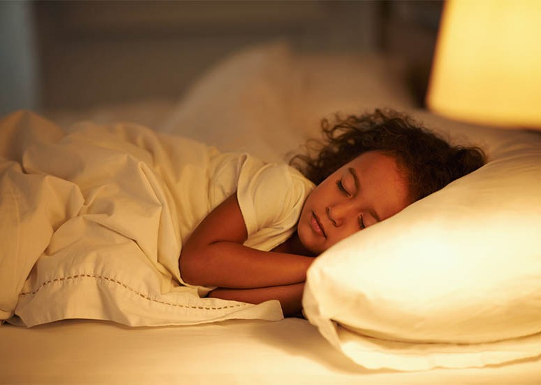 child asleep in bed
