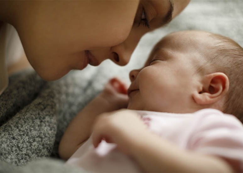 mom kissing baby