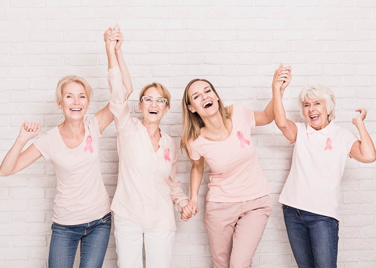 group of women wearing pink breast cancer ribbons