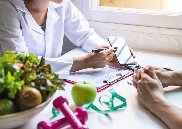 Nutritionist consulting with weight loss patient
