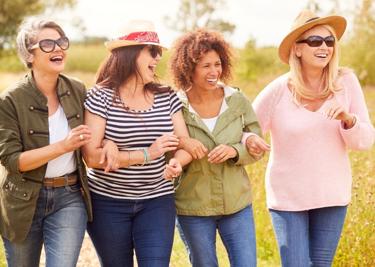 group of women walking and smiling