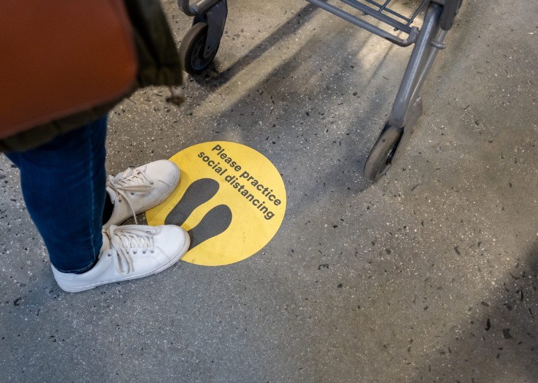 please practice social distancing sticker on ground