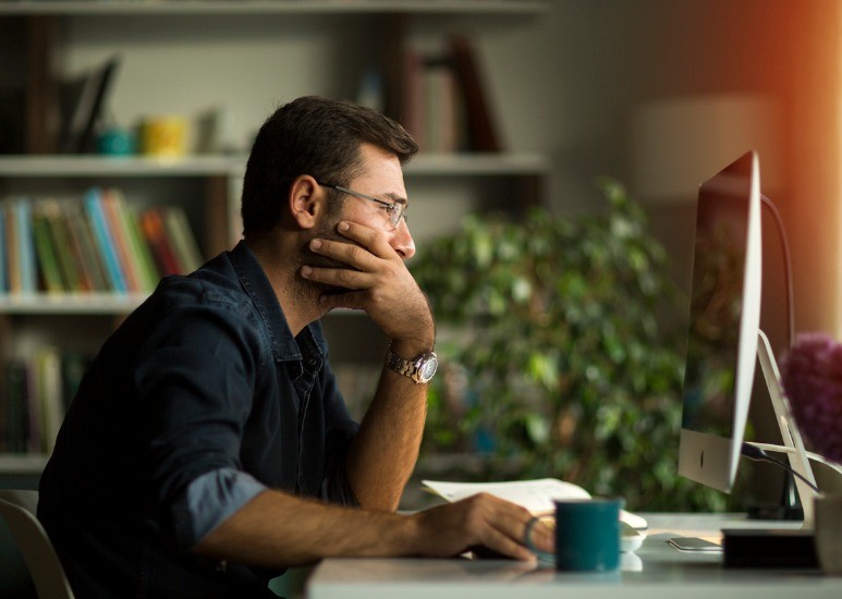 Man working from home with computer monitor