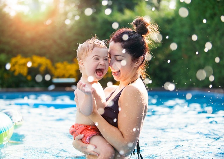 little boy with mom in pool