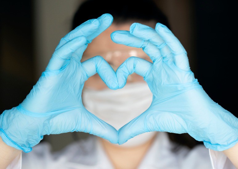 caregiver making heart with hands