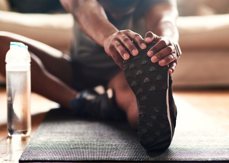 man stretching at home in living room