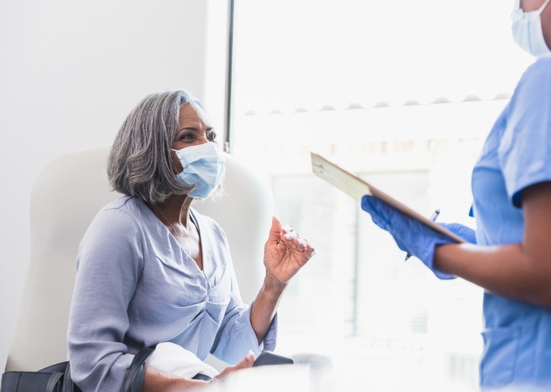 woman speaking with doctor in masks