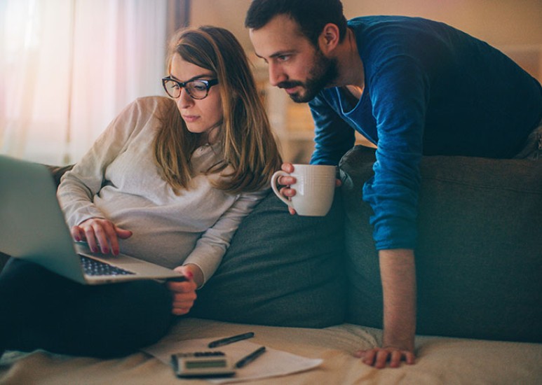 pregnant couple doing research online 