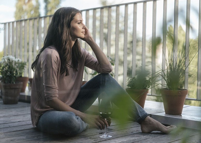 woman on deck drinking wine