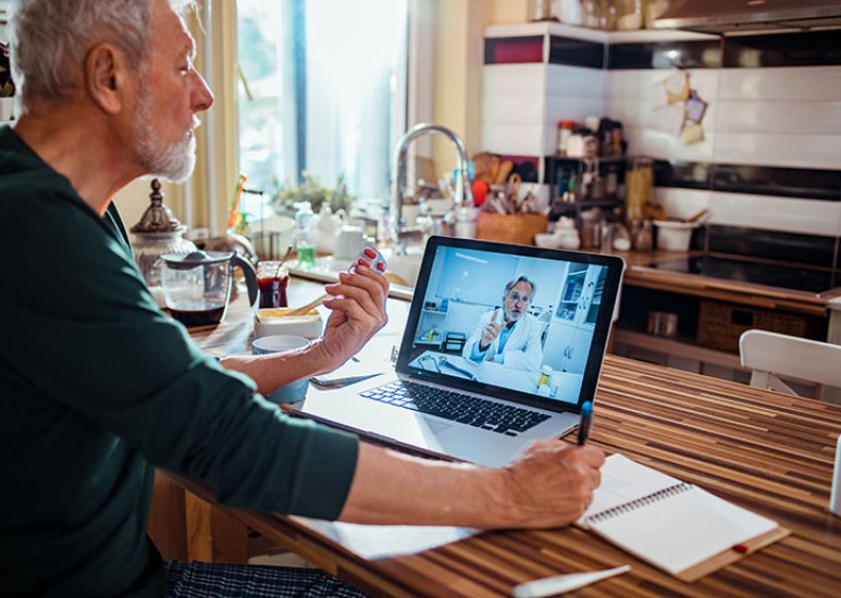 elderly man having telehealth visit 