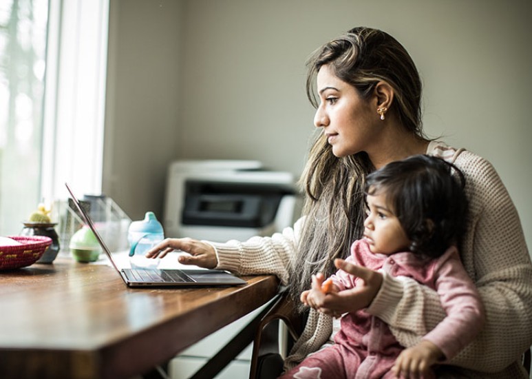 Mother and daughter on laptop at home