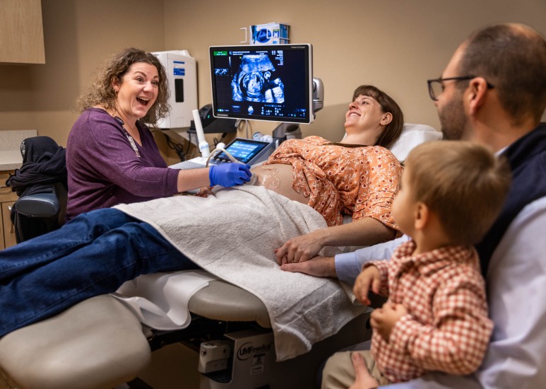 woman getting an ultrasound with her family