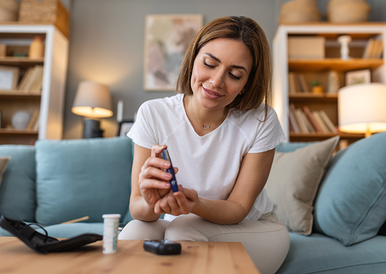 woman testing her blood sugar for diabetes