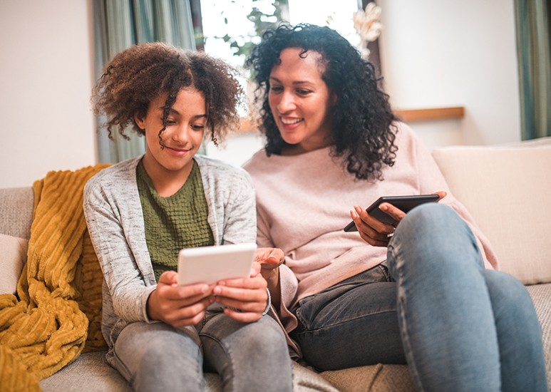 Mom and teen looking at mobile device
