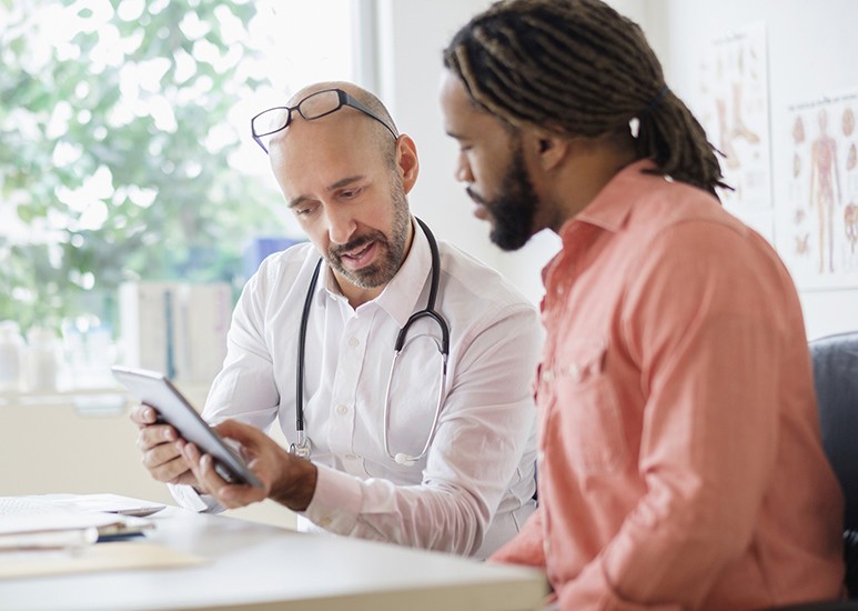 Primary care doctor and patient reviewing medical history