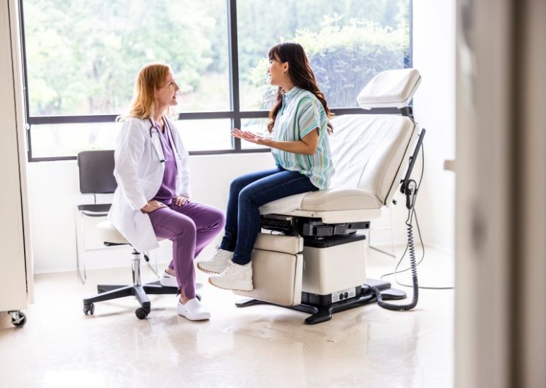 Primary care physician and a patient have a conversation in an exam room
