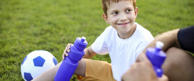 Young athlete taking a water break. 