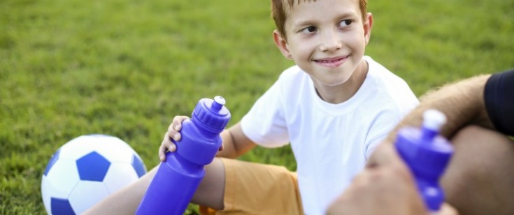 Young athlete taking a water break on the field