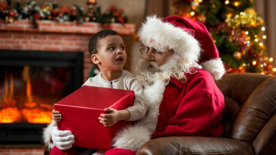 Child sitting with Santa Claus