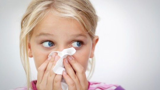 Girl blowing her nose