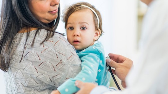 Mom holding ill baby