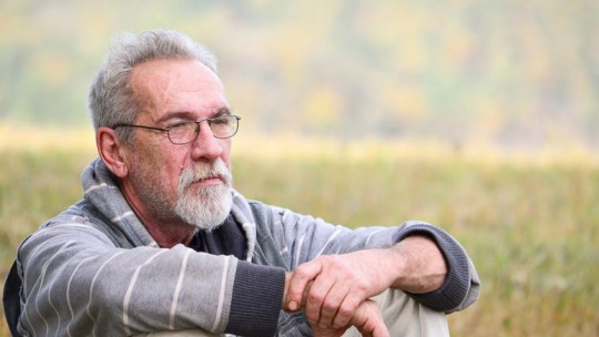 Older man sitting outside