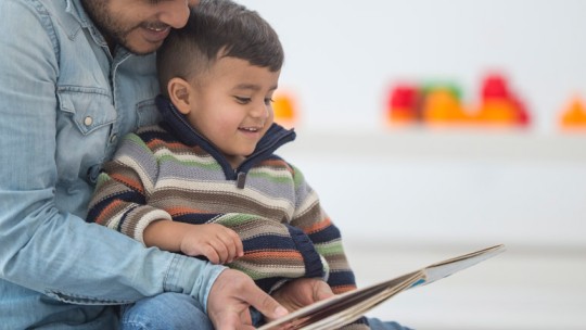 Father reading aloud to son