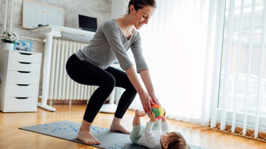 Mom exercising at home with baby