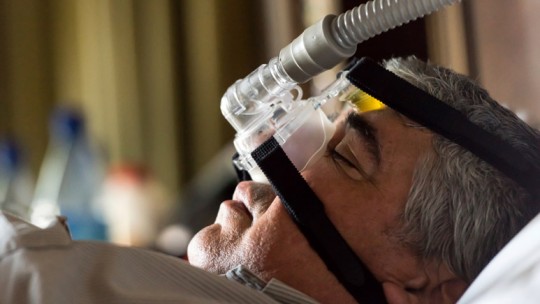 Older man sleeping with sleep apnea mask
