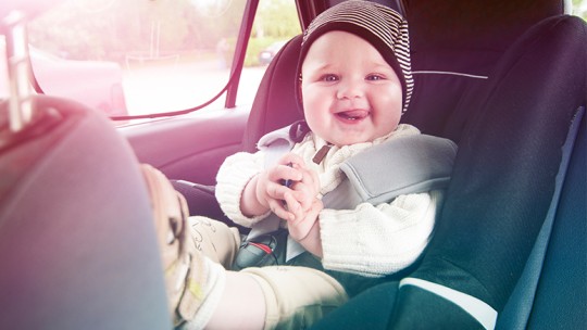 Infant in car seat in back seat of car