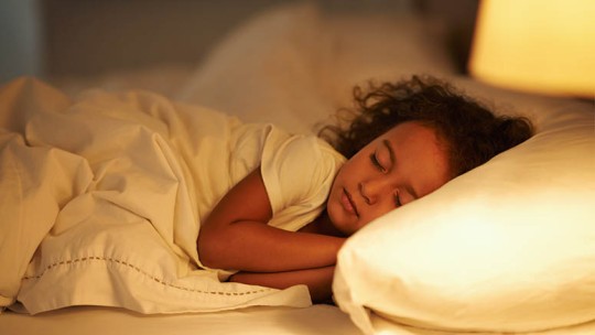 child asleep in bed