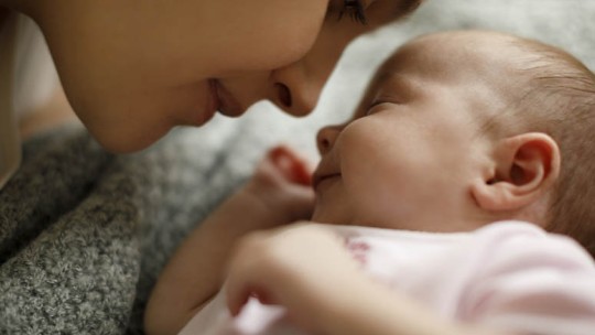 mom kissing baby