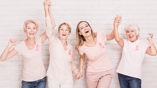 group of women wearing pink breast cancer ribbons