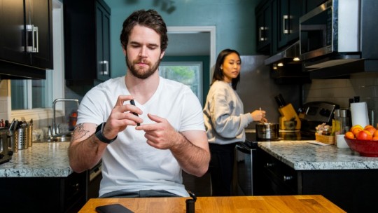 Young man checking his blood sugar level