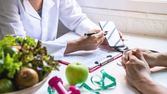 Nutritionist consulting with weight loss patient