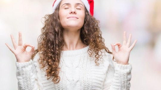 Woman wearing Santa hat destressing