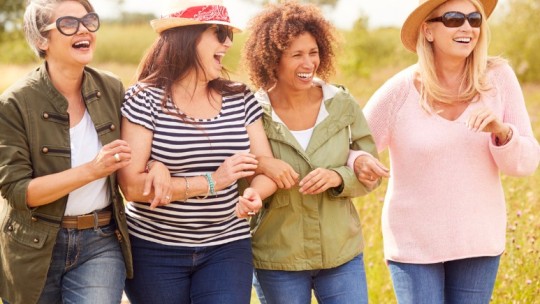 group of women walking and smiling
